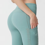 Nylon nude side pocket yoga pants hollow stitching hip-lifting tight-fitting sports running fitness pants
